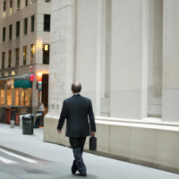 common man walking on Wall Street