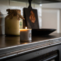 a photo of a candle in a beautiful farm style kitchen